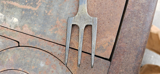 Carved trident fork